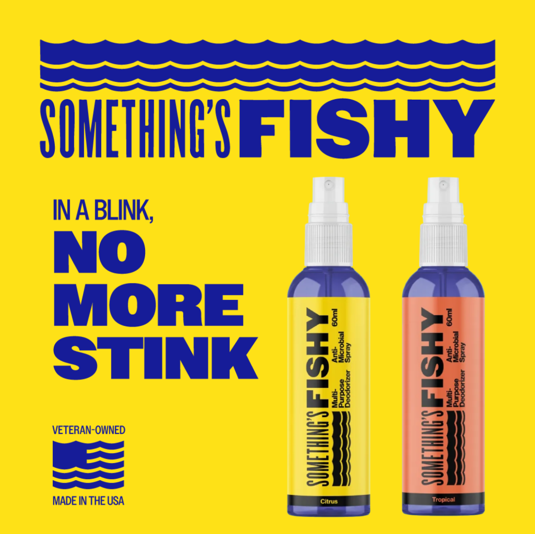 Two bottles of 'Something's Fishy' deodorant spray on a yellow background with blue text.